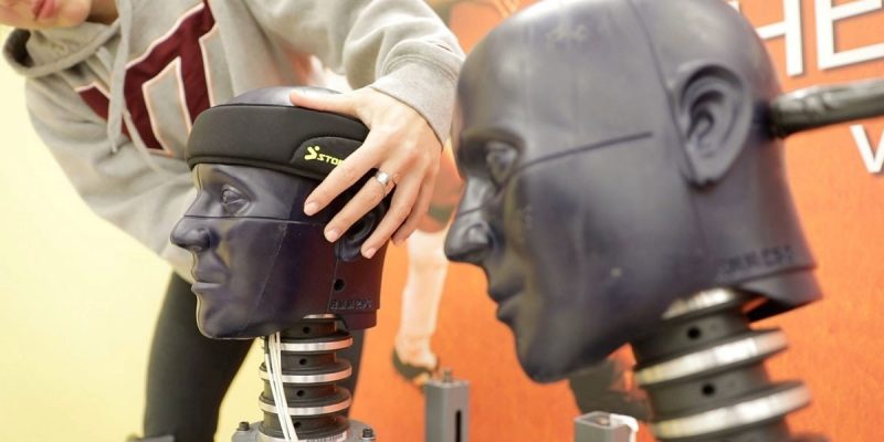 A photo of a person testing headgear in the The Virginia Tech Helmet Lab.