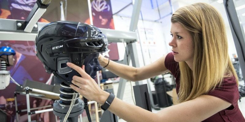 A photo of doctoral student Megan Bland setting up an impact test in the Virginia Tech Helmet Lab.