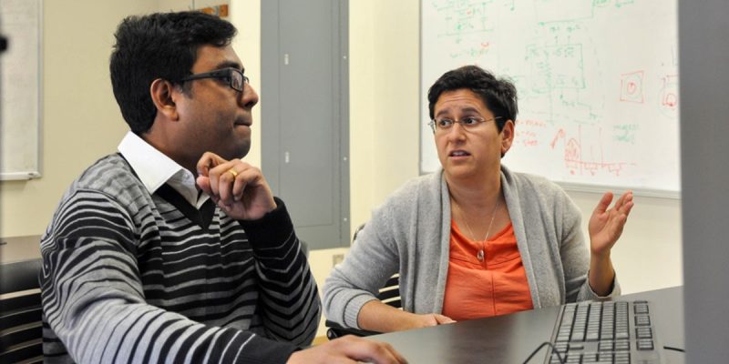 A photo of Subhradeep Roy (left) and Nicole Abaid in the Complex Systems Laboratory at Virginia Tech.