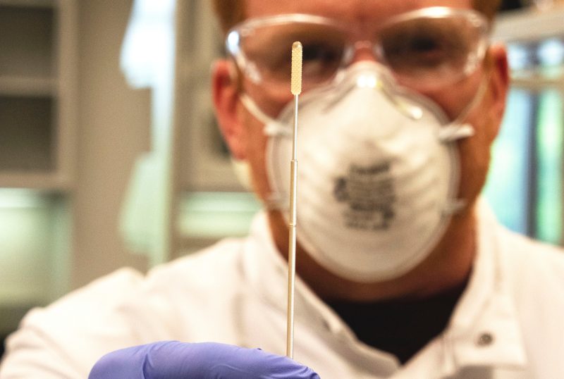 Marc Michel, an associate professor in the Department of Geosciences, holds up a nasopharyngeal swab that he 3D printed in a lab at Steger Hall.