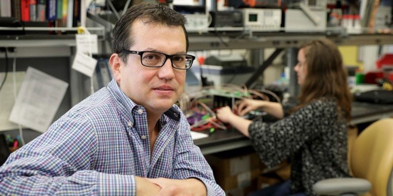 A photo of Rafael Davalos, professor of biomedical engineering and mechanics at Virginia Tech, in a lab with another researcher.