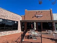 View of The Maroon Door - brick building with outdoor seating shown