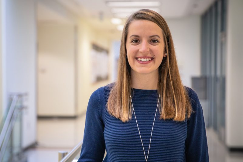 Portrait of Grace Wusk in a blue shirt in Kelly Hall