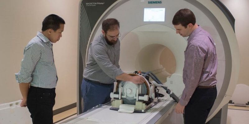 Stephen LaConte, Douglas Chan, and Nate Kelm with an MRI