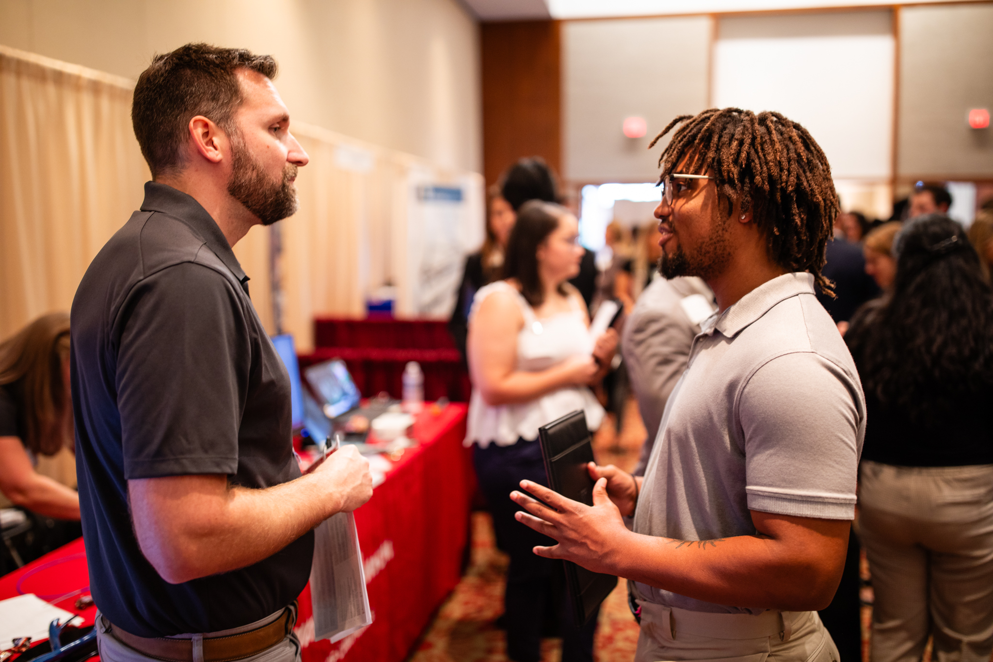 Employer speaks with a student regarding potential employment opportunities 