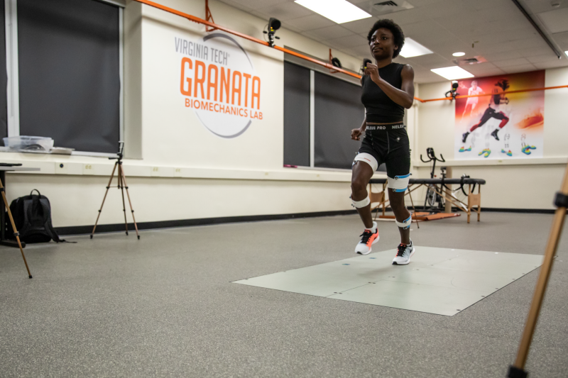 Student running with sensory measures on limbs, in Granata Lab