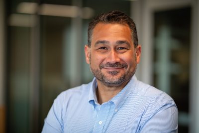 Headshot of Miguel Perez in light blue shirt