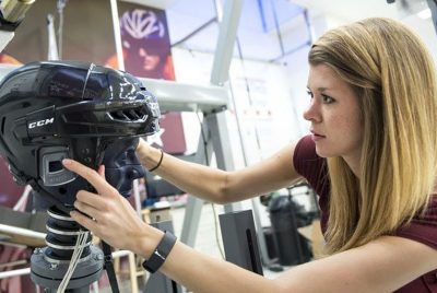 Graduate student Megan Bland prepares a hockey helmet for testing.