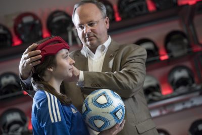 Stefan Duma fits soccer headgear in the Helmet Lab