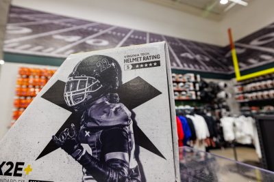 Football helmet packaging featuring a player dressed in uniform wearing a black helmet