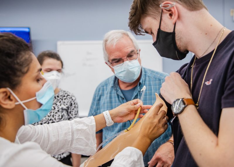 Elham Morshedzadeh and Andre Muelenaer, professor of practice in biomedical engineering and mechanics, with students during the summer 2021 design sprint. Photo by Spencer Roberts of Virginia Tech.